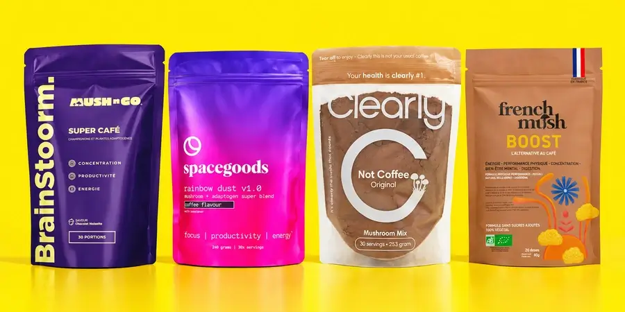 Confezioni di Brainstoorm, Spacegoods Rainbow Dust, Clearly Not Coffee e French Mush Boost allineate su fondo giallo